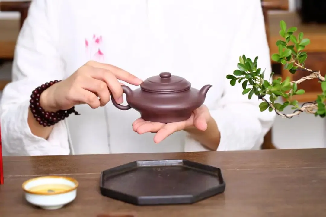 Flat purple clay teapot