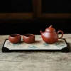 Complete Yixing Gongfu Tea Set including a teapot and two teacups arranged on an elegant bamboo-patterned tea tray, presented on a rustic wooden surface