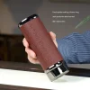 Demonstrating the leak-proof design of a Yixing Tumbler, held upside down to show its food-grade sealing silicone ring and 360° portability, ideal for daily commutes and travel