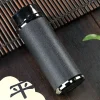 Black variant of a Yixing Tumbler displayed on a bamboo mat, showcasing its sleek, modern appearance and durable, scratch-resistant exterior for versatile use