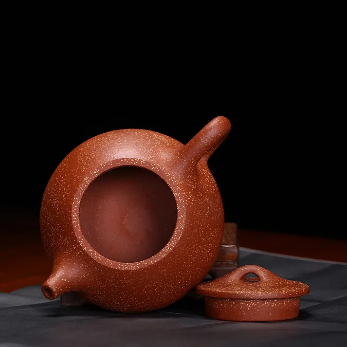 Large Purple Clay Yixing Teapot 240ML 6 Large Purple Clay Yixing Teapot in use, ideal for oolong and pu-erh tea brewing