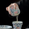Pouring tea from an Antique Gaiwan into a matching pitcher, showcasing the functional design of this Best Gaiwan Tea Set.