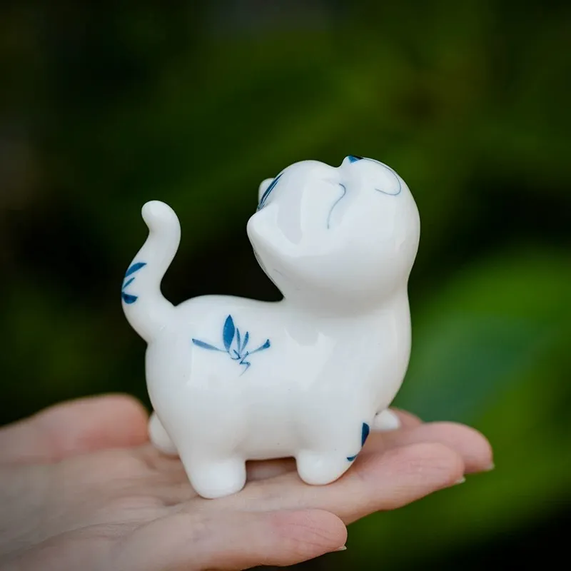Hand-Painted Sassy Cat Ceramic Tea Pet 8 Mini hand-painted blue and white Cat Tea Pet held in palm to show compact size