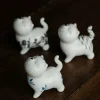 Hand-Painted Sassy Cat Ceramic Tea Pet 12 3 assorted hand-painted Cat Tea Pet designs displayed on dark wooden tea table