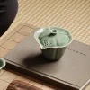 Gaiwan with Strainer placed on a fabric mat, highlighting the celadon finish and practical Gaiwan Tea Infuser for traditional tea time.