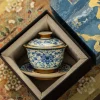 Porcelain Gaiwan Tea Set nestled in a luxury gift box, featuring detailed blue and white artwork for an elegant presentation.
