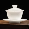 150ml Gaiwan with lid and saucer on a wooden table, a minimalist Chinese Tea Gaiwan made from glossy white porcelain for tea ceremonies.