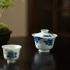 Dehua Porcelain Gaiwan paired with a matching teacup, set against a tranquil tea table backdrop.