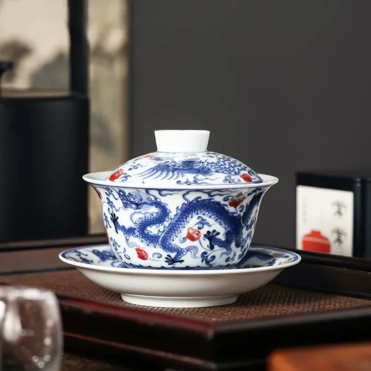 Dragon and Phoenix Auspicious Stoneware Gaiwan 165ml 6 Dragon Gaiwan placed on a tea tray, blending traditional Chinese craftsmanship with the practical design of a Stoneware Gaiwan.
