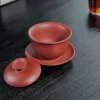 A red Yixing Clay Gaiwan with lid removed, revealing its smooth interior and classic design for traditional tea brewing.
