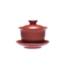 A vibrant red Yixing Gaiwan with lid and saucer, presented against a clean white background to highlight its sleek, minimalist form.