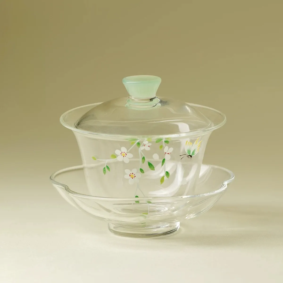 Made of Borosilicate Glass Gaiwan 95ml 1 Complete Gaiwan Made of Borosilicate Glass set with lid and flower-shaped saucer, featuring hand-painted floral and butterfly patterns, displayed against a neutral background.