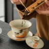 Adding tea leaves to a Cat Gaiwan, demonstrating the traditional tea preparation process with this beautifully patterned gaiwan.
