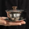 Handheld Titanium Gaiwan with lid, highlighting its compact size and premium metallic aesthetic for portable tea enjoyment.
