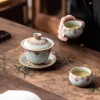 Ru Kiln Vintage Dunhuang Treasure Flower Gaiwan Tea Set 160ml 9 Ru Kiln Gaiwan paired with 2 matching teacups, part of a Vintage Gaiwan Tea Set, displayed on a bamboo-patterned tea mat during a traditional tea ceremony.