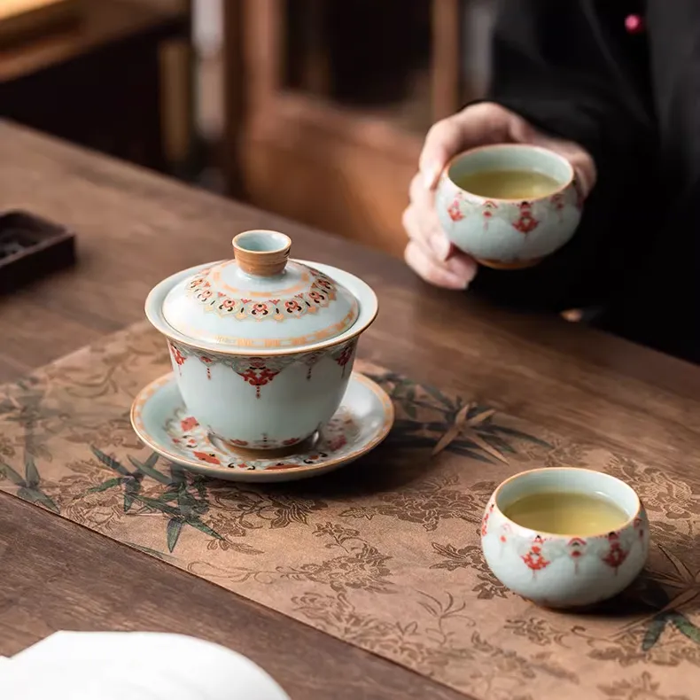Ru Kiln Vintage Dunhuang Treasure Flower Gaiwan Tea Set 160ml 3 Ru Kiln Gaiwan paired with 2 matching teacups, part of a Vintage Gaiwan Tea Set, displayed on a bamboo-patterned tea mat during a traditional tea ceremony.