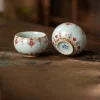 Ru Kiln Vintage Dunhuang Treasure Flower Gaiwan Tea Set 160ml 13 Two matching teacups from a Vintage Gaiwan Tea Set, crafted from Ru Kiln porcelain with crackled glaze and vintage red floral patterns.