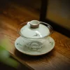 Empty Gaiwan Glass with hand-painted bamboo artwork, resting on its saucer, highlighting its transparent and delicate structure.