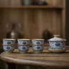 Traditional Blue and White Ru Kiln Gaiwan Tea Set 140 ml 15 Traditional Gaiwan Tea Set with 6 matching teacups, featuring intricate blue floral patterns on this Ruyao Gaiwan, displayed on a rustic wooden table.