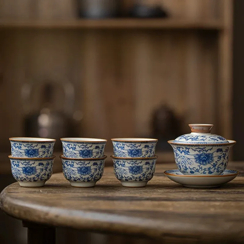 Traditional Blue and White Ru Kiln Gaiwan Tea Set 140 ml 6 Traditional Gaiwan Tea Set with 6 matching teacups, featuring intricate blue floral patterns on this Ruyao Gaiwan, displayed on a rustic wooden table.