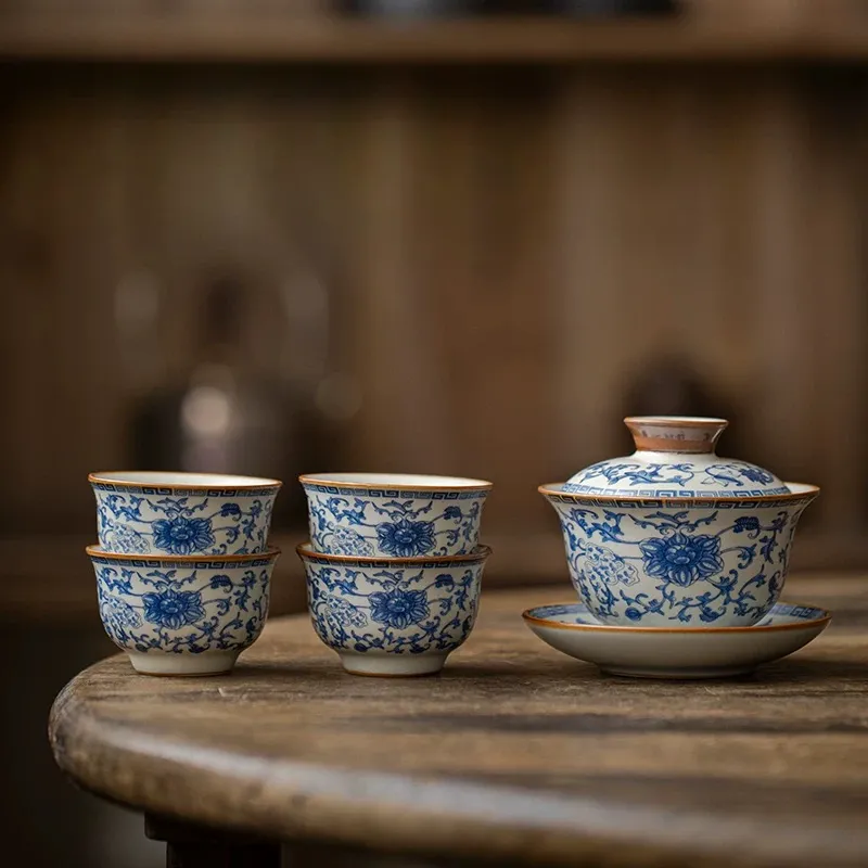 Traditional Blue and White Ru Kiln Gaiwan Tea Set 140 ml 7 Traditional Gaiwan Tea Set with 4 teacups, showcasing the detailed blue underglaze patterns on this elegant Ruyao Gaiwan against a warm wooden backdrop.