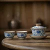 Traditional Blue and White Ru Kiln Gaiwan Tea Set 140 ml 17 Ruyao Gaiwan paired with 2 matching teacups, part of a Traditional Gaiwan Tea Set, highlighting the classic blue floral motifs on the porcelain surface.
