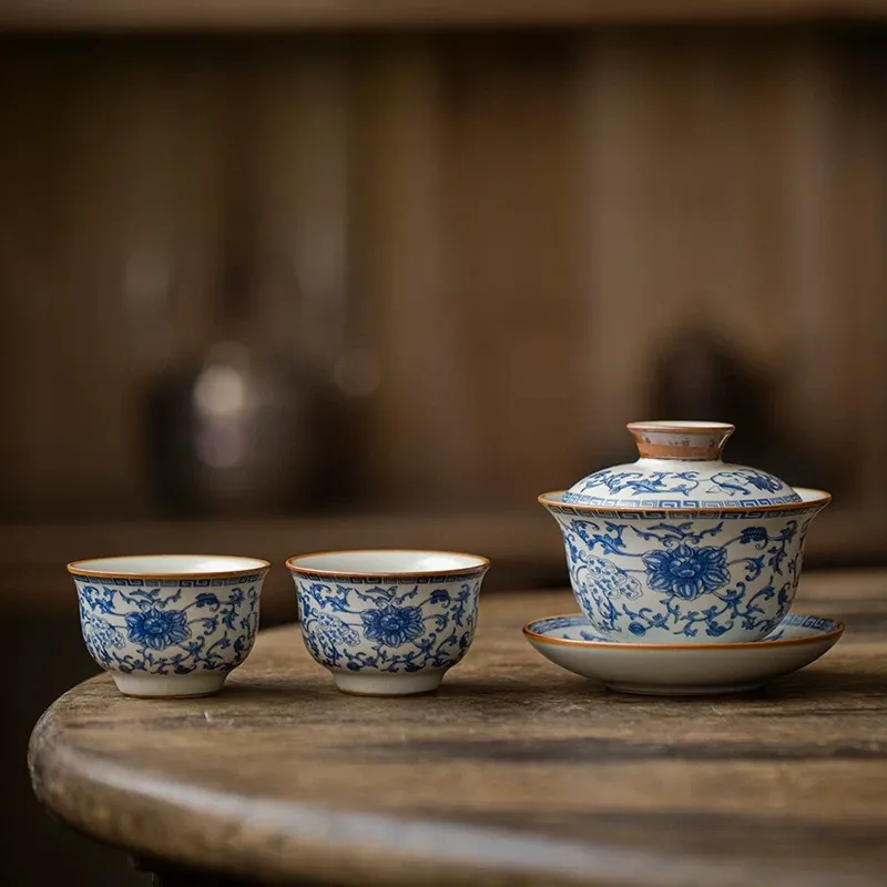 Traditional Blue and White Ru Kiln Gaiwan Tea Set 140 ml 8 Ruyao Gaiwan paired with 2 matching teacups, part of a Traditional Gaiwan Tea Set, highlighting the classic blue floral motifs on the porcelain surface.