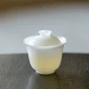 Mini Gaiwan, 50ml Gaiwan: Elegant white porcelain gaiwan with translucent finish, perfect for traditional tea brewing on dark wooden surface