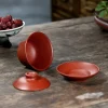 Disassembled Purple Clay Gaiwan from Yixing on wooden table with red dates in porcelain bowl